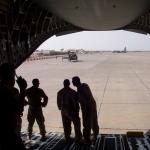 Rodriguez stands with other servicemembers in an aircraft
